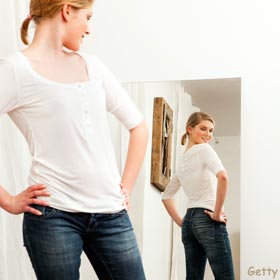 woman-looking-body-mirror